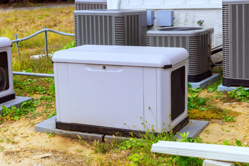 Whole-home generator in a yard outside of a home.